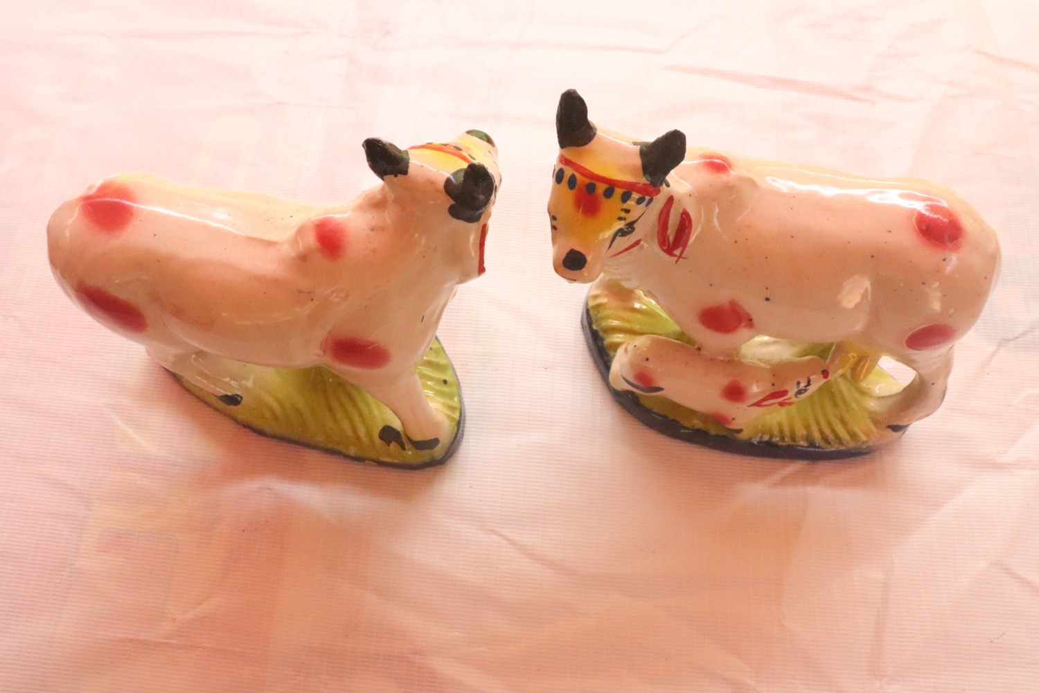A pair of small, hand-painted, ceramic cows Naidupeta